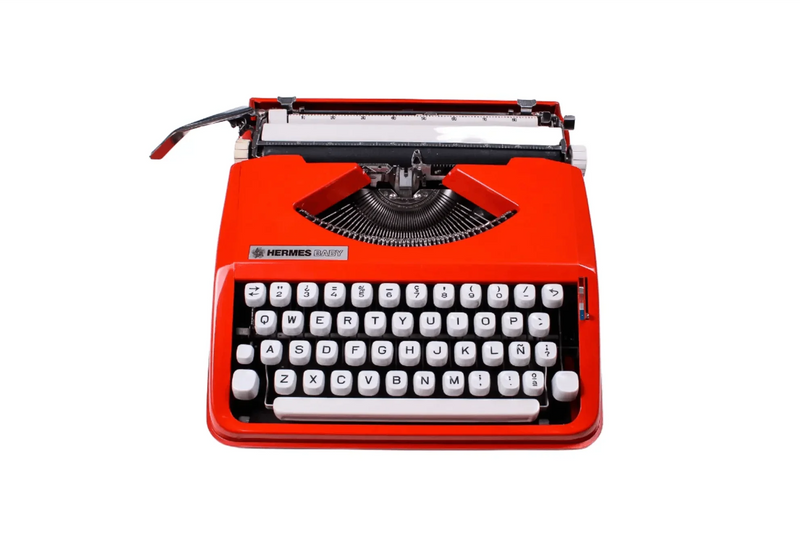 Hermes Baby portable typewriter in orange, restored by El Granero.
