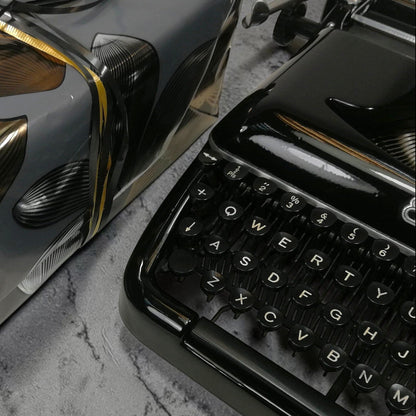 ElGranero Typewriter.Company premium gift wrap with black and gold floral paper, ribbon, and a vintage typewriter.
