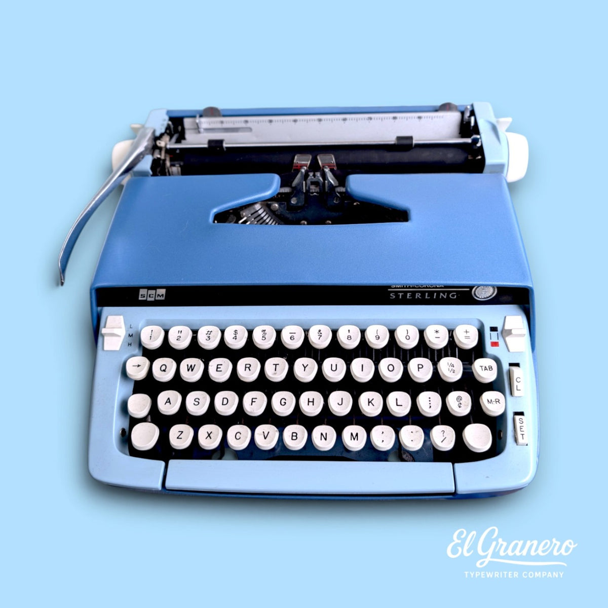 Smith-Corona Sterling blue portable typewriter, front view with US QWERTY keyboard